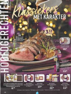 Beef roast joint on a platter surrounded by Christmas lights. 