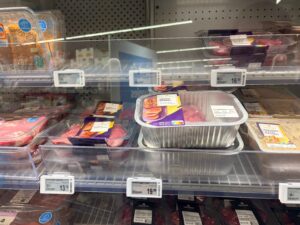 Foil dish encases a wagyu joint on a refrigerated shelf