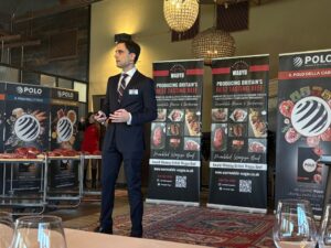Man talking in front of pull up banners