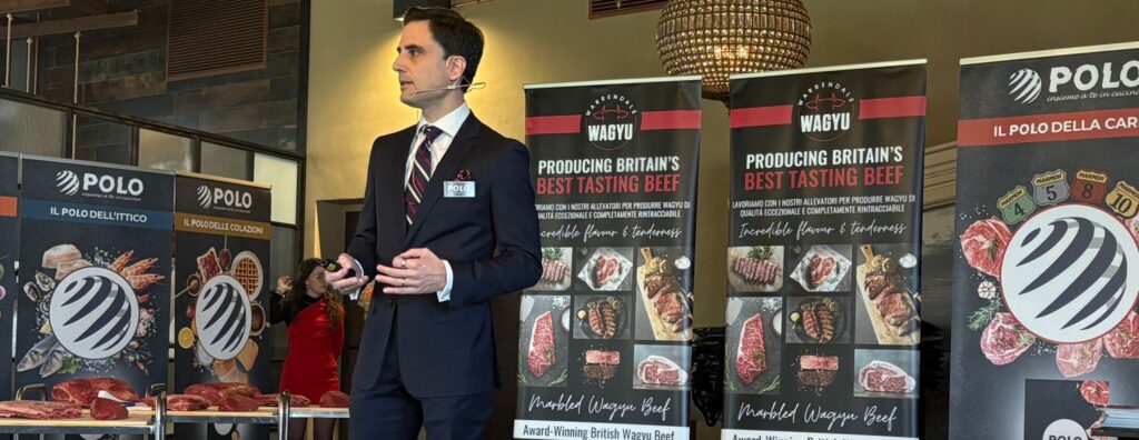 Man talking in front of pull up banners