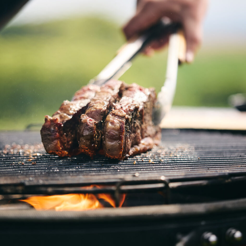 meat being cooked on a barbecue