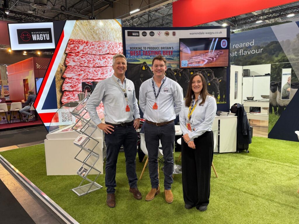two men and one lady at an exhibition stand
